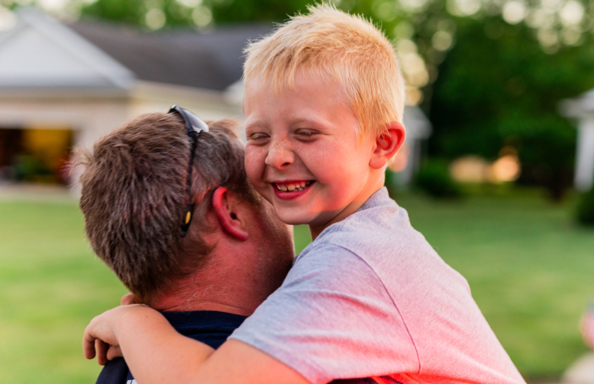 Child hugging his father