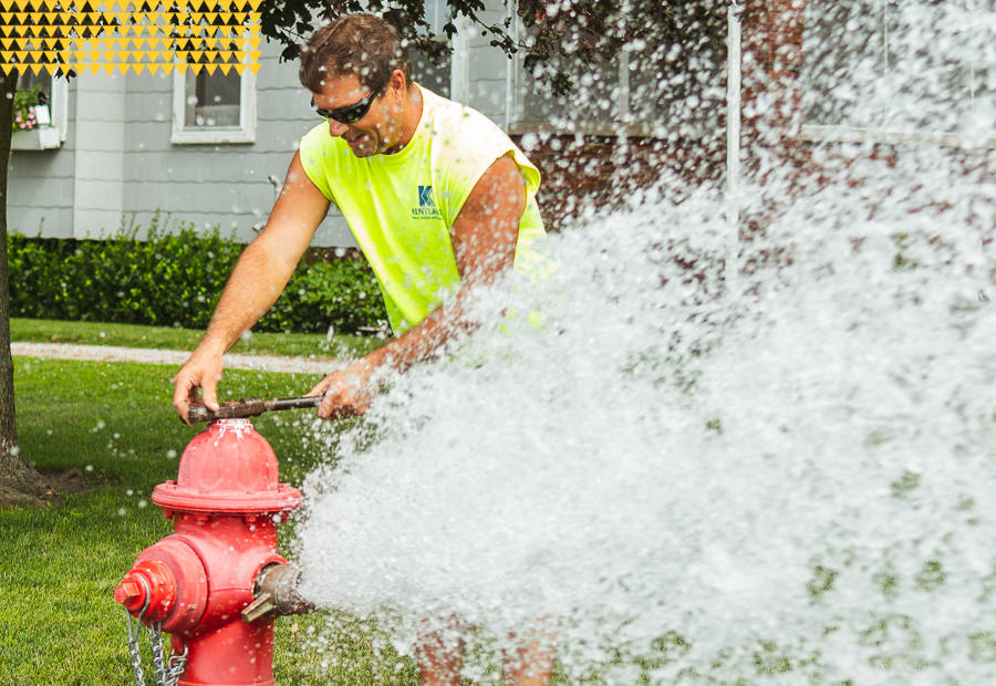 Public Works employee releasing water from fire hydrant